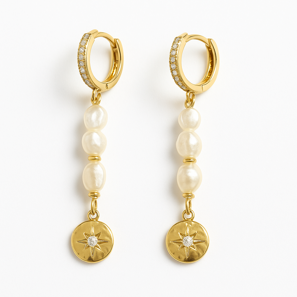 Gold hoop earrings with pearl beads and circular charms on a white background