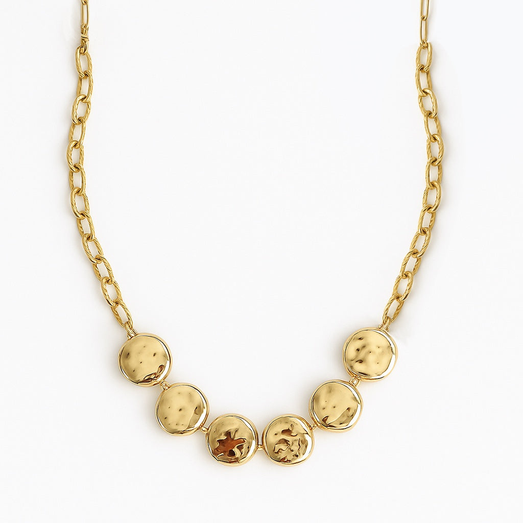 Gold necklace with round pendants on a white background