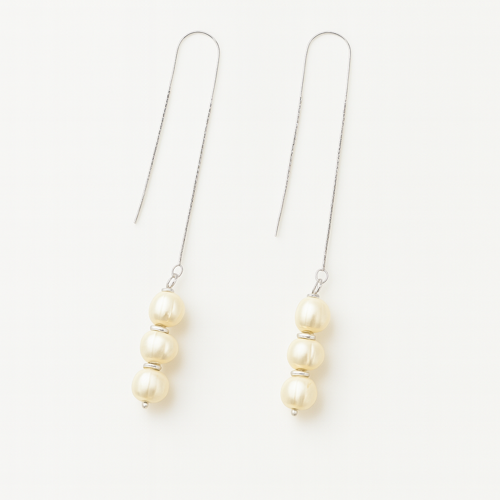 Pair of pearl drop earrings on a white background