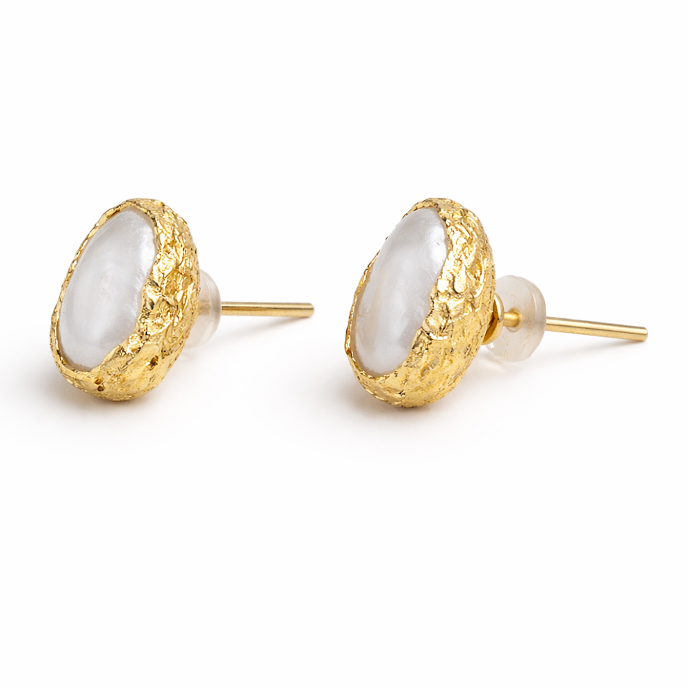 Gold earrings with white stones on a white background