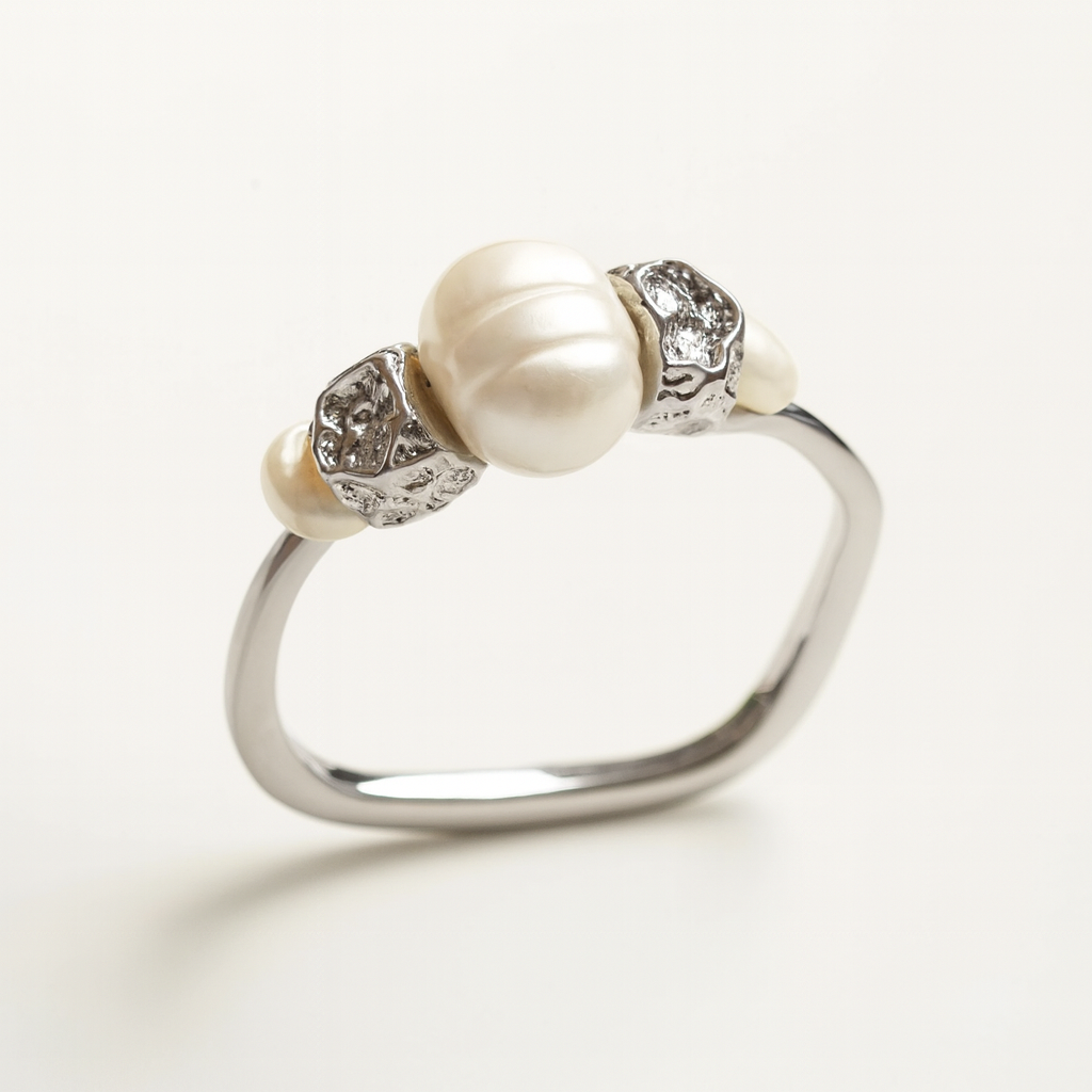 Silver ring with pearls and gemstones on a white background