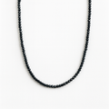 Black beaded necklace on a white background