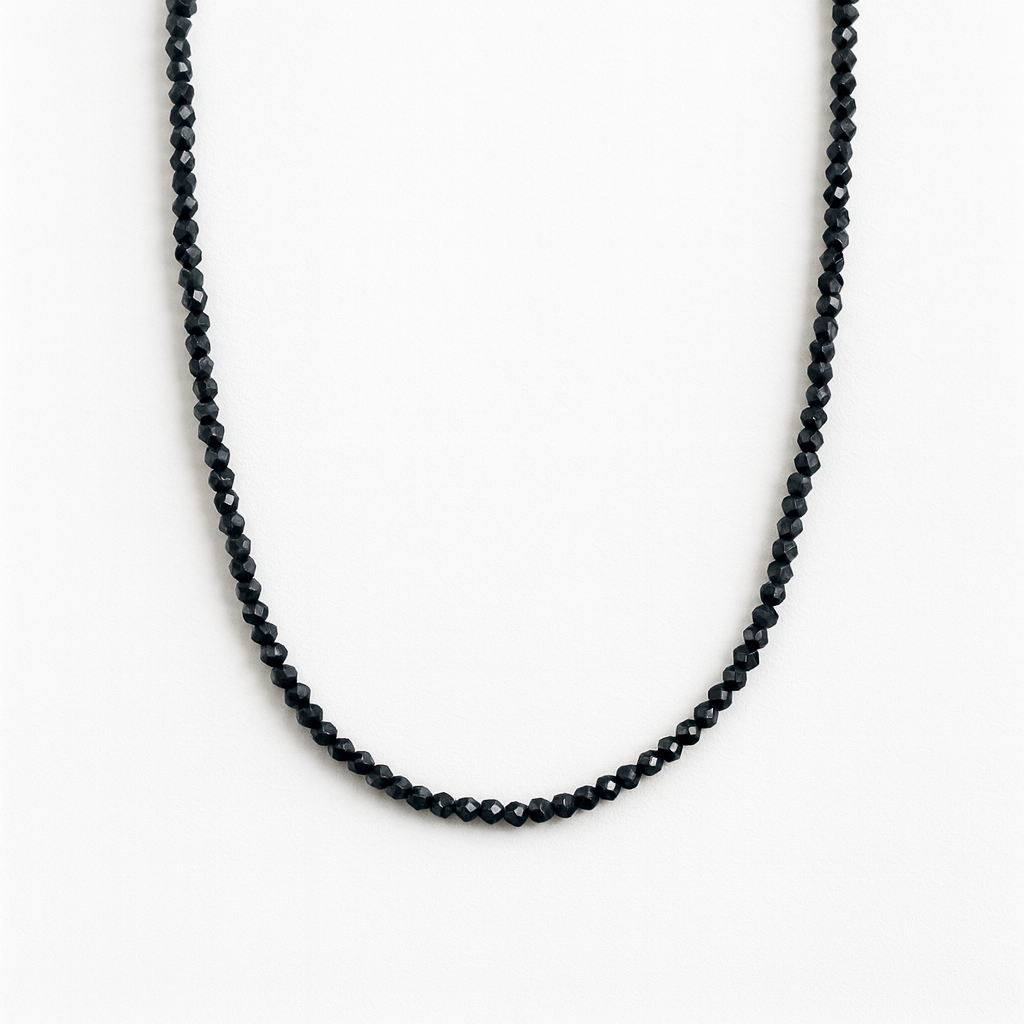 Black beaded necklace on a white background