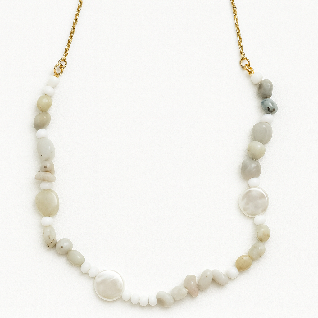 Necklace with natural stone beads on a gold chain against a white background