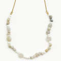 Necklace with natural stone beads on a gold chain against a white background