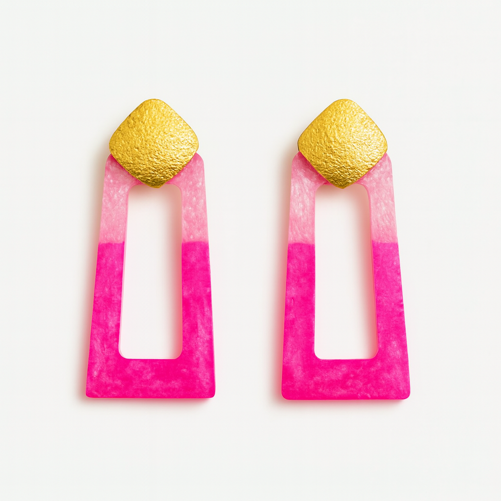 Pair of earrings with pink and gold design on a white background