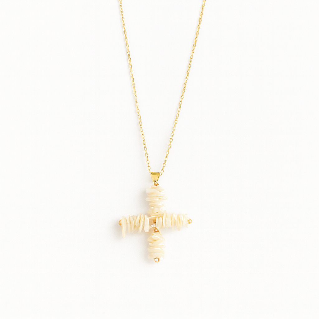 Gold cross-shaped pendant necklace on a white background