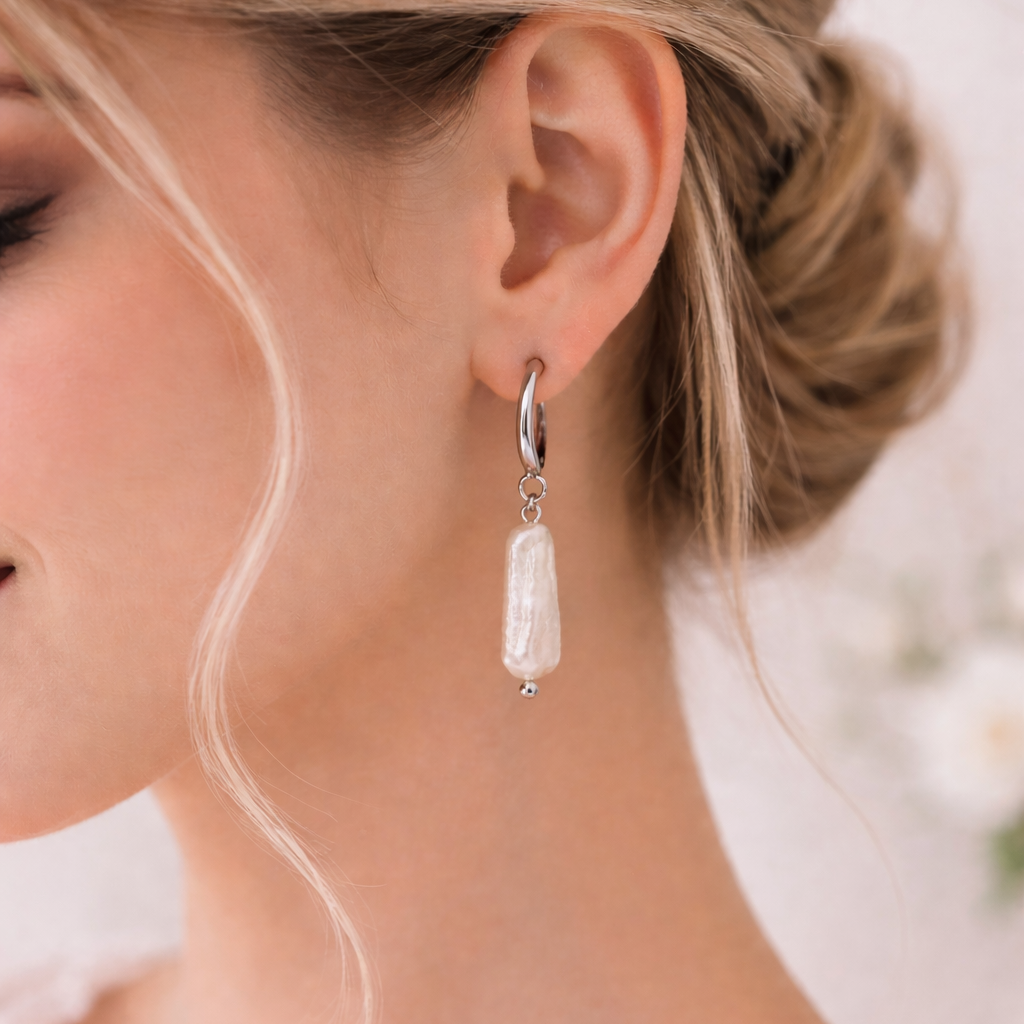 Close-up of a woman wearing a pearl earring with a blurred background
