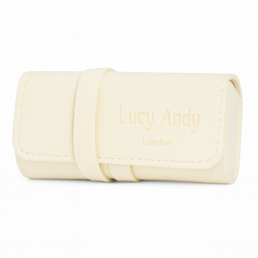 Cream-colored jewelry roll with 'Lucy Andy London' branding on a white background