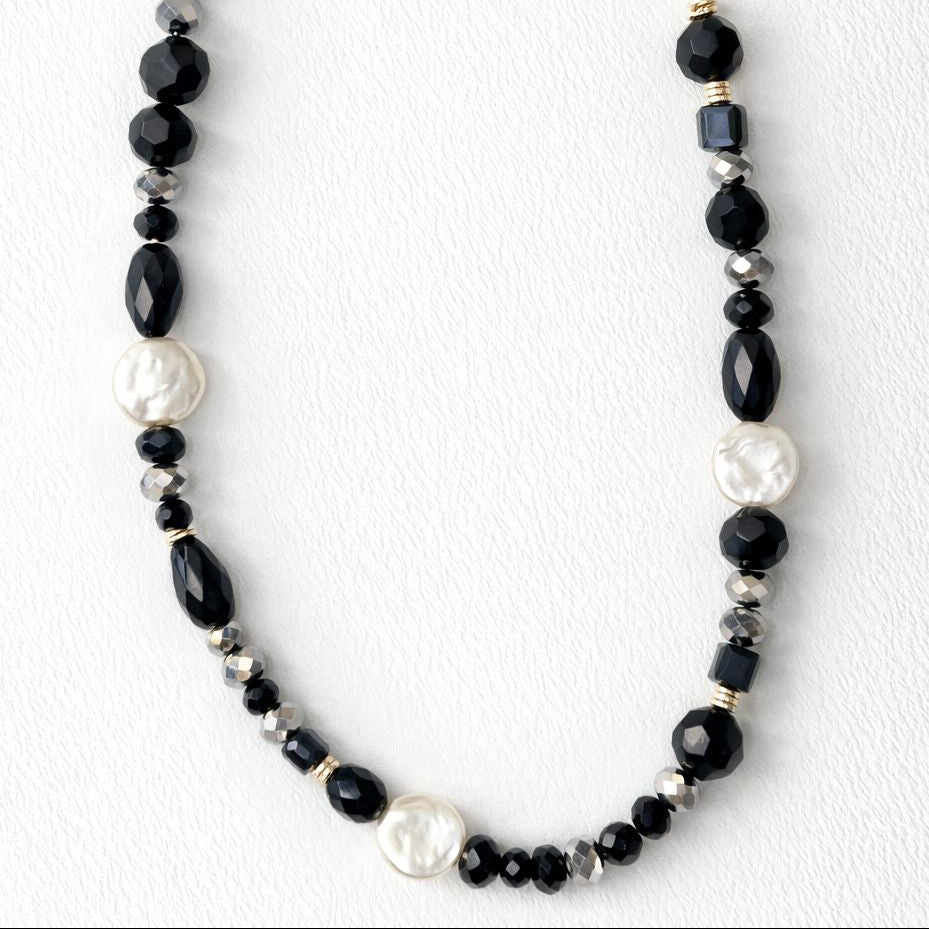 Necklace with black and white beads on a white background