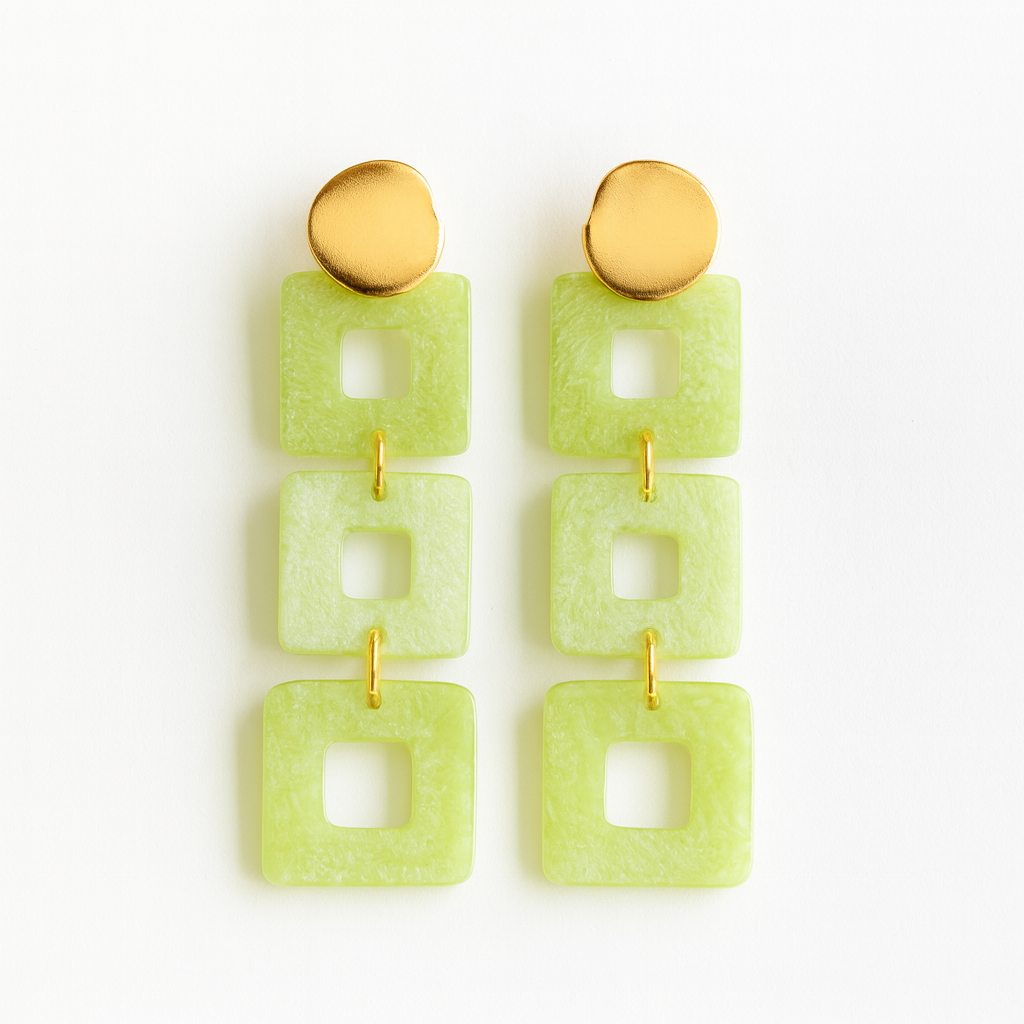 Pair of green square earrings with gold posts on a white background