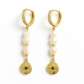 Gold hoop earrings with pearl beads and green gemstone charms on a white background