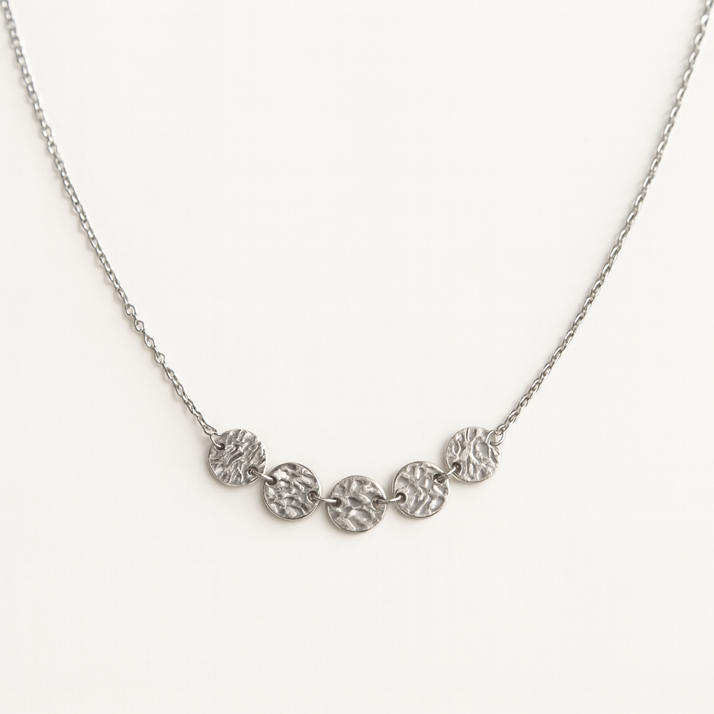 Silver necklace with circular pendants on a white background