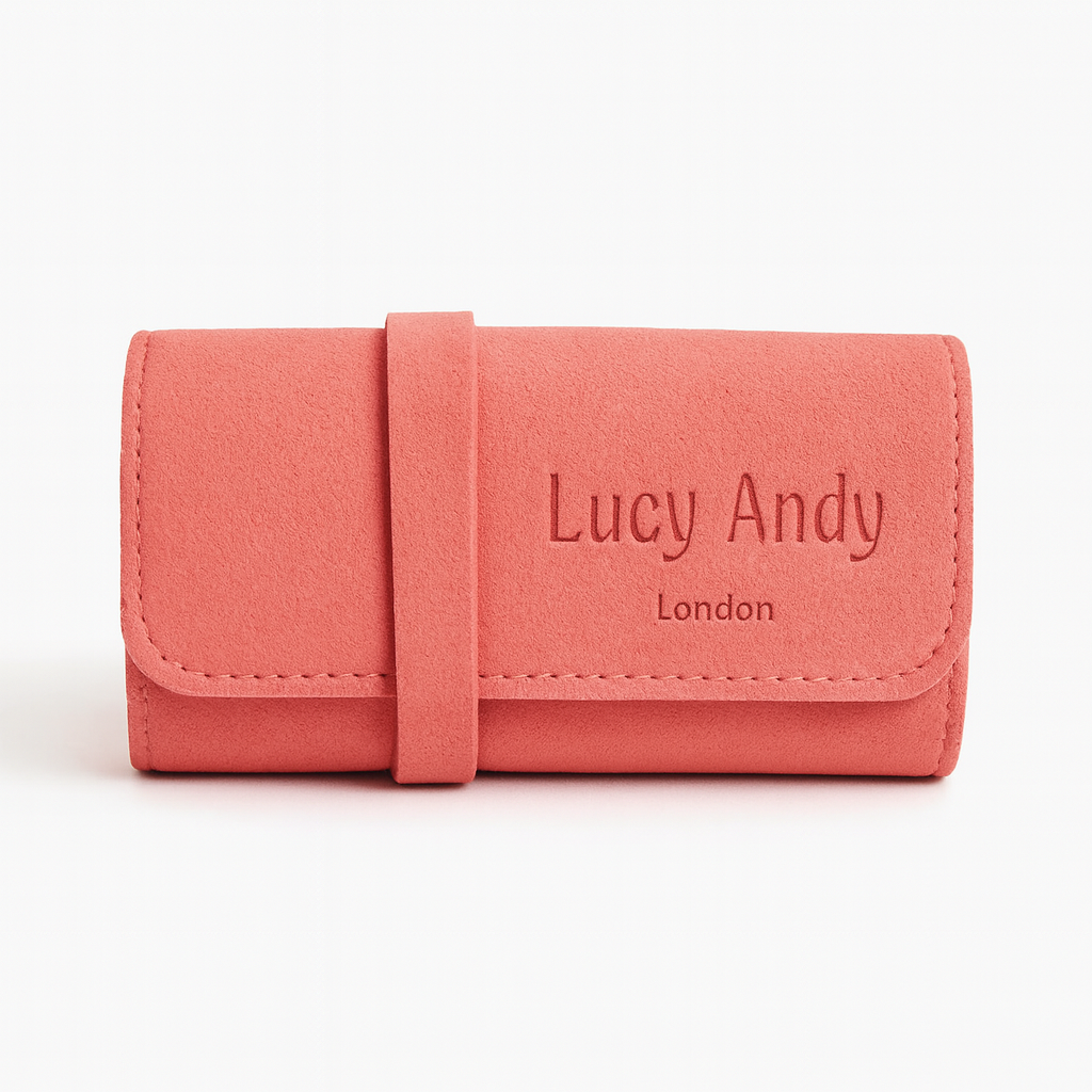 Pink wallet with 'Lucy Andy London' branding on a white background