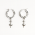 Silver hoop earrings with palm tree charms on a white background