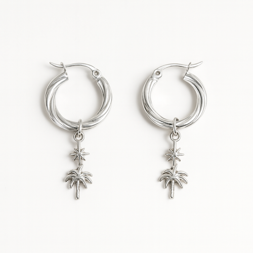 Silver hoop earrings with palm tree charms on a white background