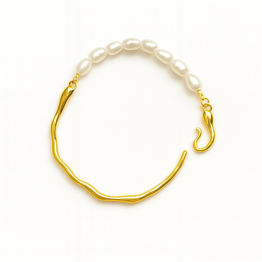 Gold bracelet with white pearls on a white background