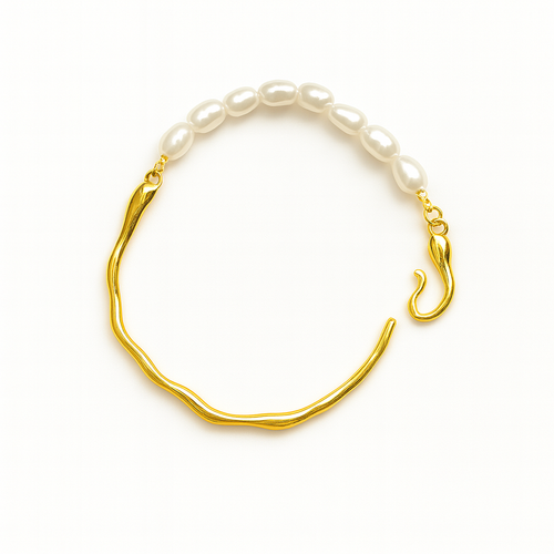 Gold bracelet with white pearls on a white background
