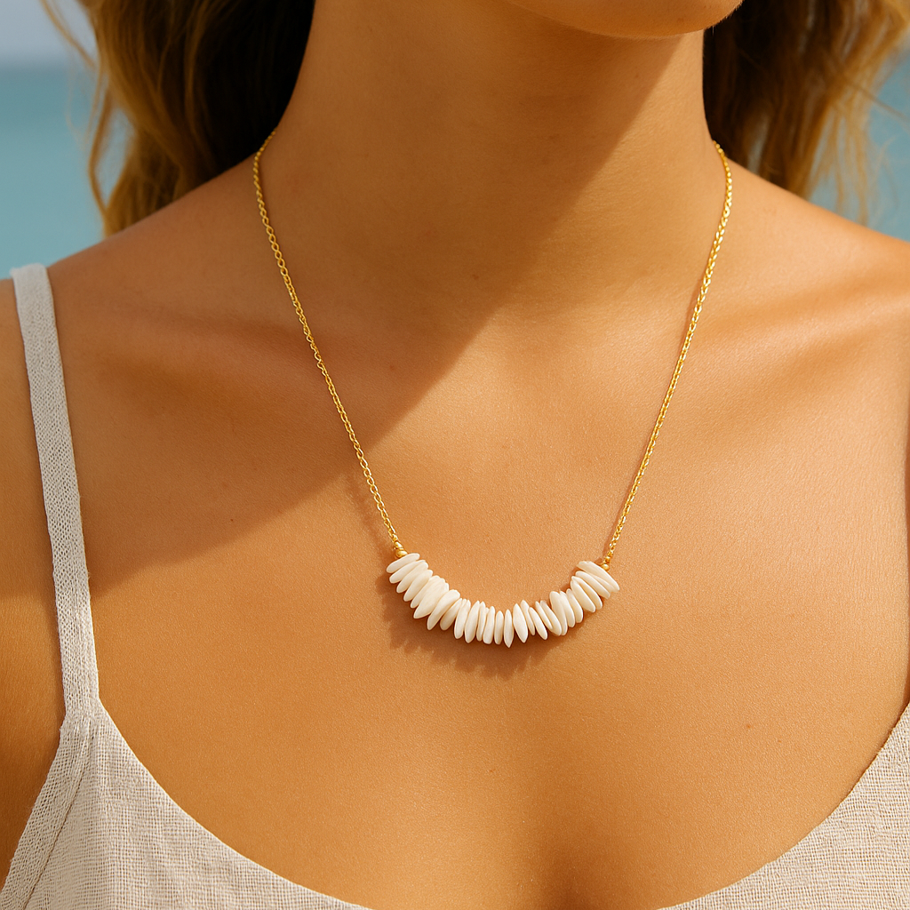 Woman wearing a gold necklace with white beads against a blurred natural background