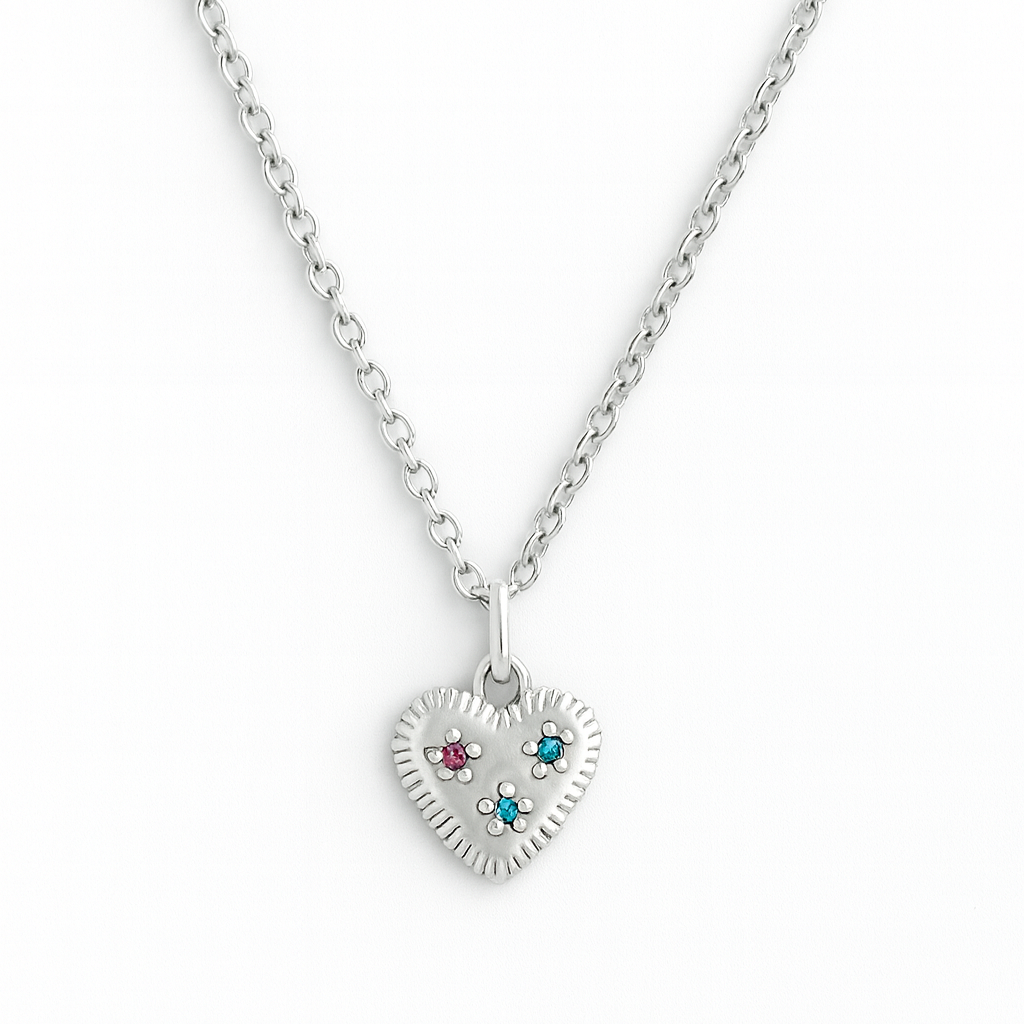 Silver heart-shaped pendant necklace with gemstones on a white background