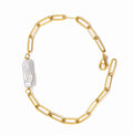 Gold chain bracelet with a large pearl on a white background