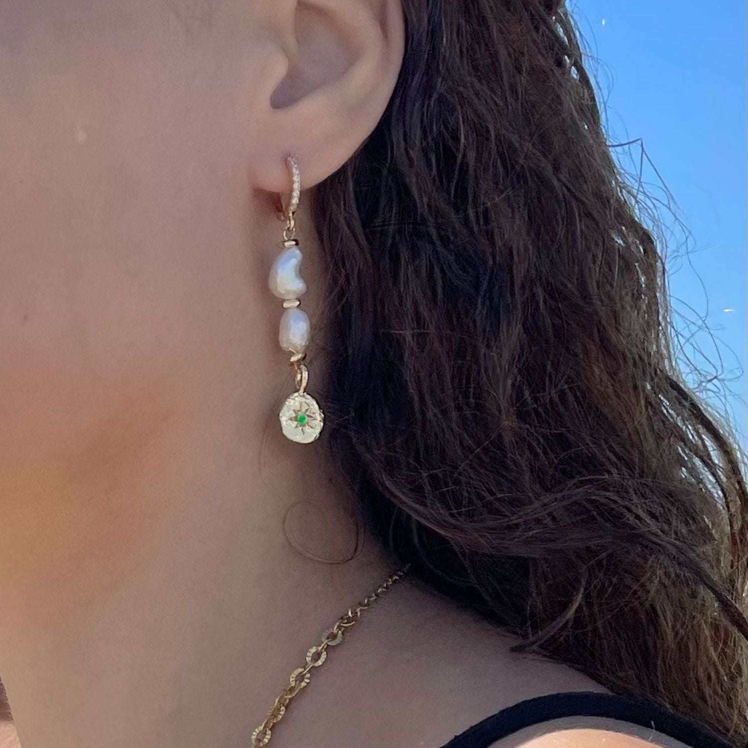 Close-up of an earring with a blue sky background