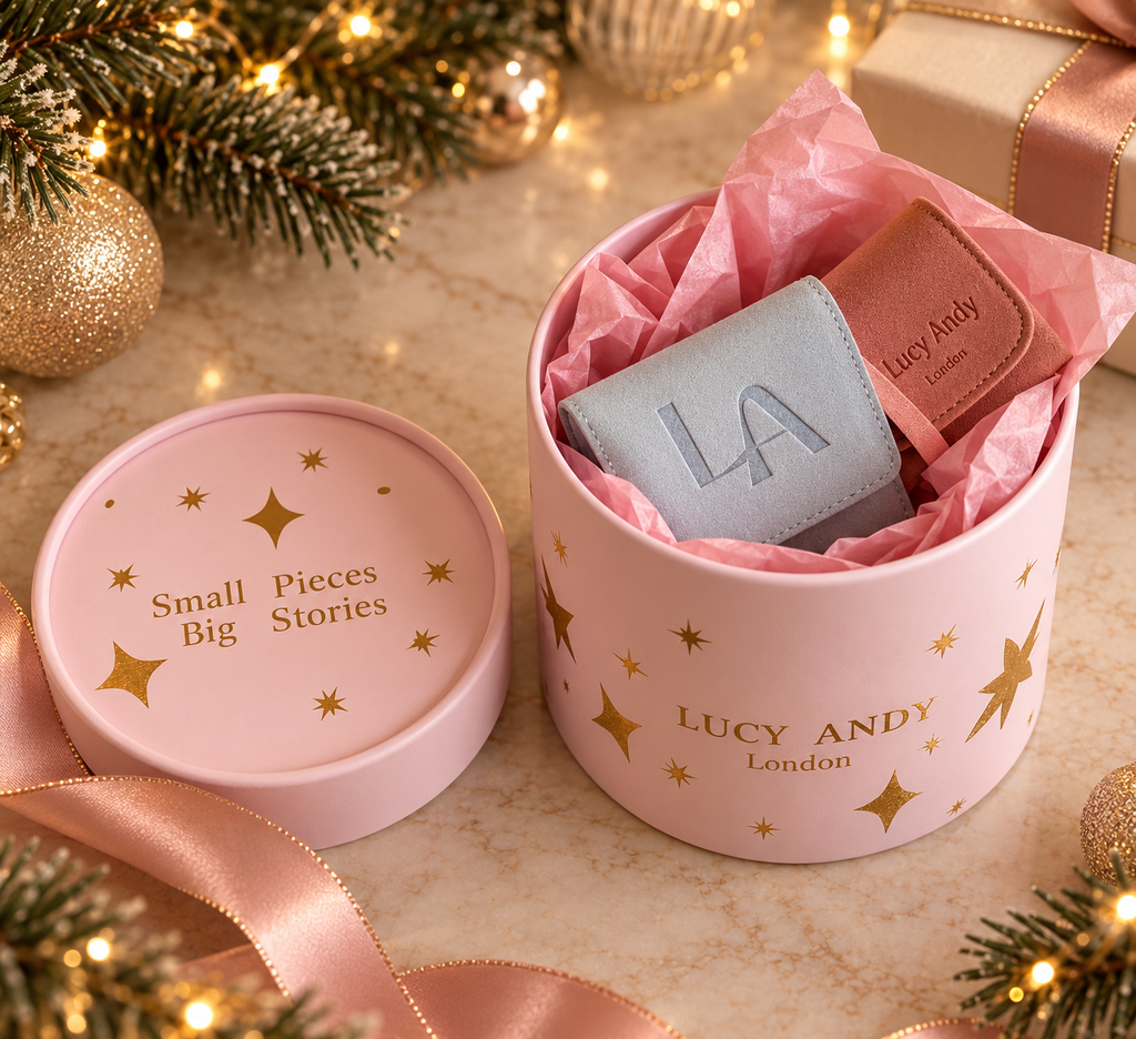 the lucy andy pink round gift set open with a roller light blue  velvet pounch and pink travel bag inside in a warmy christmas background 