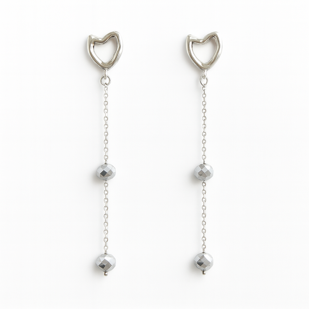 Pair of silver cat ear drop earrings with chain and bead details on a white background