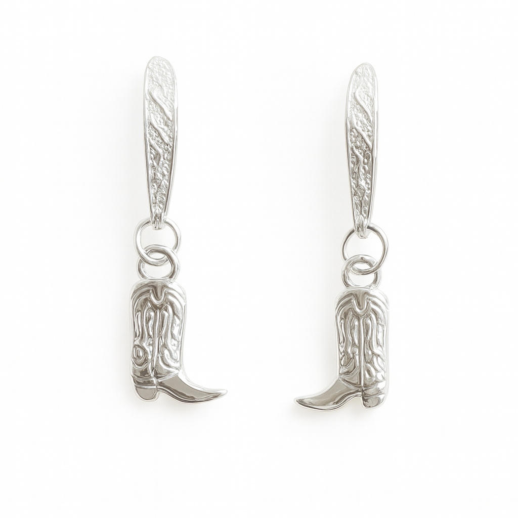 Silver cowboy boot earrings on a white background