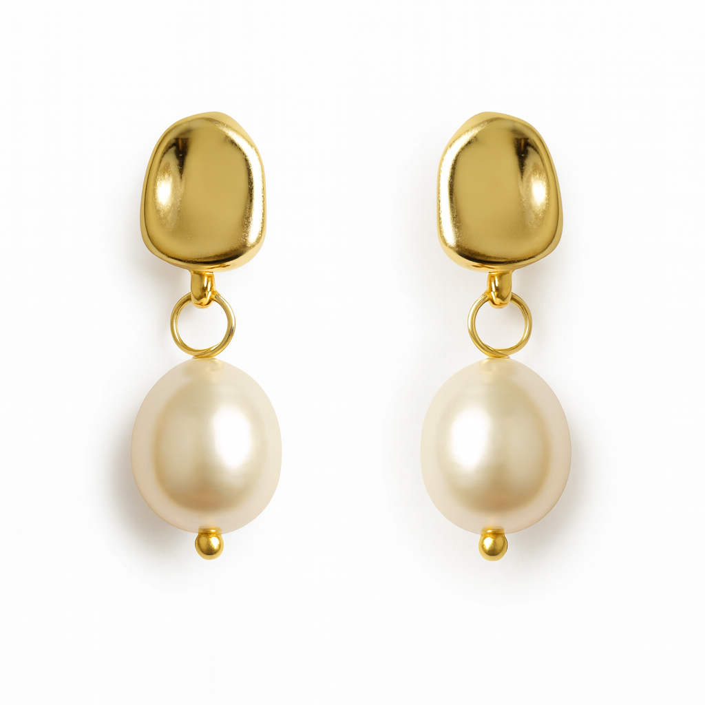 Gold earrings with pearl drops on a white background