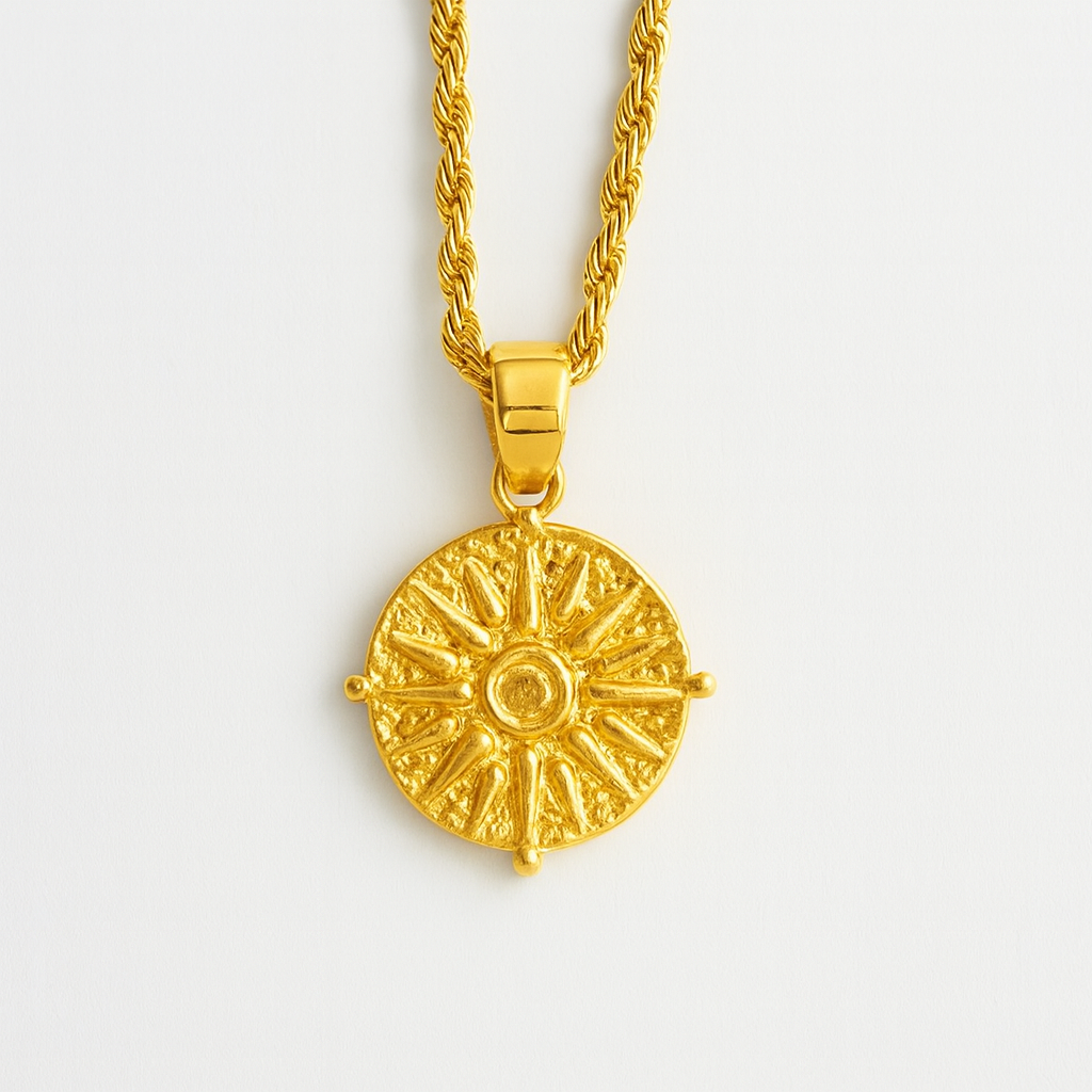 Gold necklace with a detailed pendant on a light gray background
