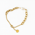 Gold chain bracelet with a pearl and round charm on a white background