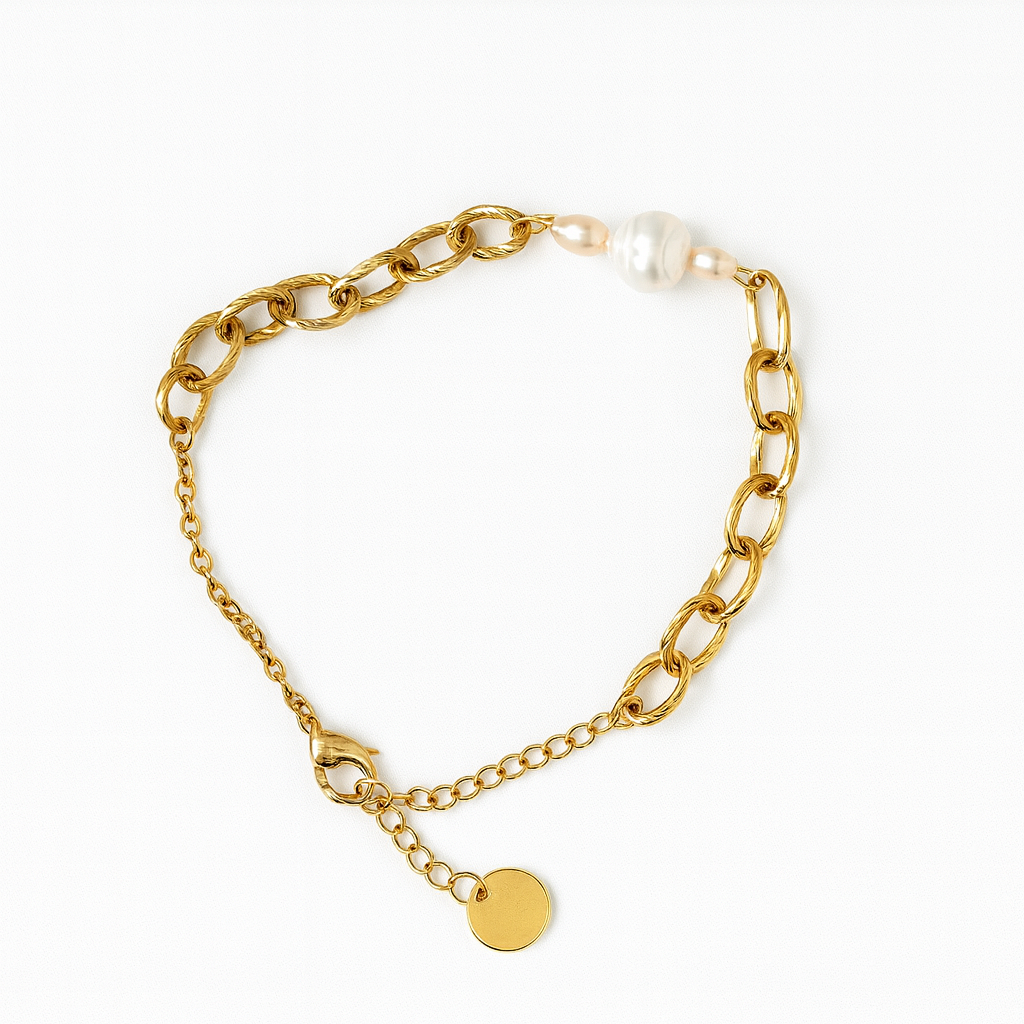 Gold chain bracelet with a pearl and round charm on a white background