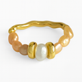 Gold ring with pearls on a white background