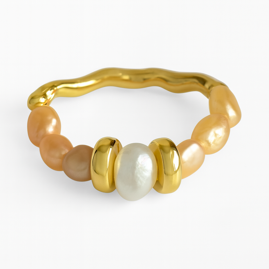 Gold ring with pearls on a white background