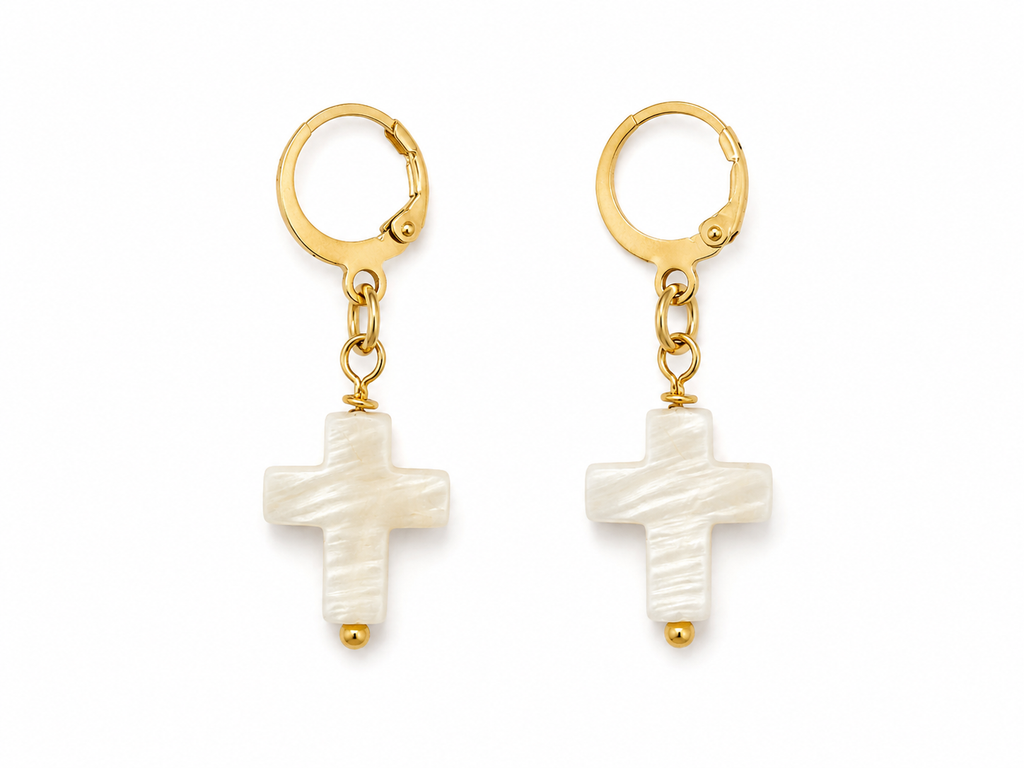 delicate gold hoop earring with a small white cross dangle
