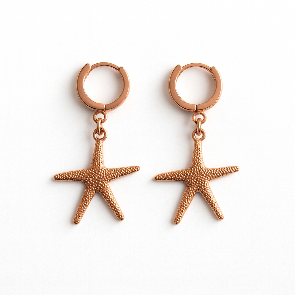 Rose gold starfish earrings on a white background