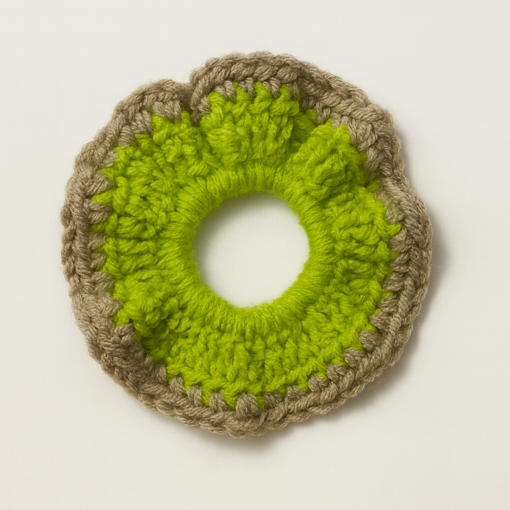 Crocheted green and brown circular item on a light beige background