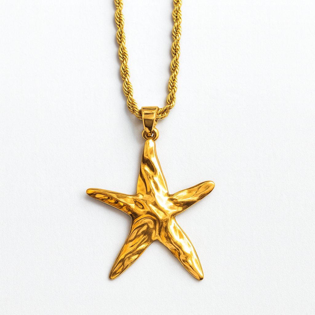 Gold starfish pendant on a gold chain against a white background