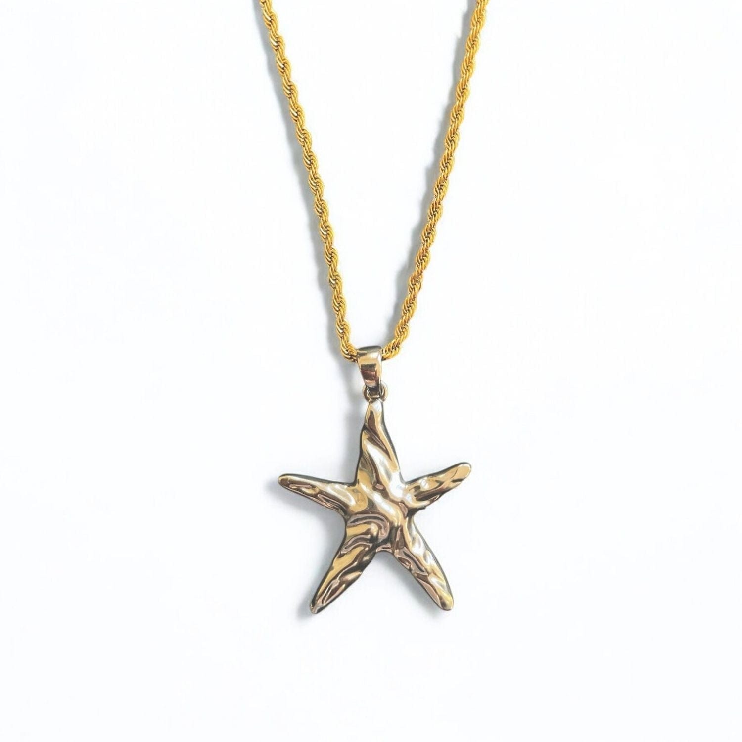 Gold starfish pendant on a gold chain against a white background